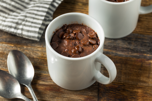 A mug filled with chocolate cake and melty chocolate chips